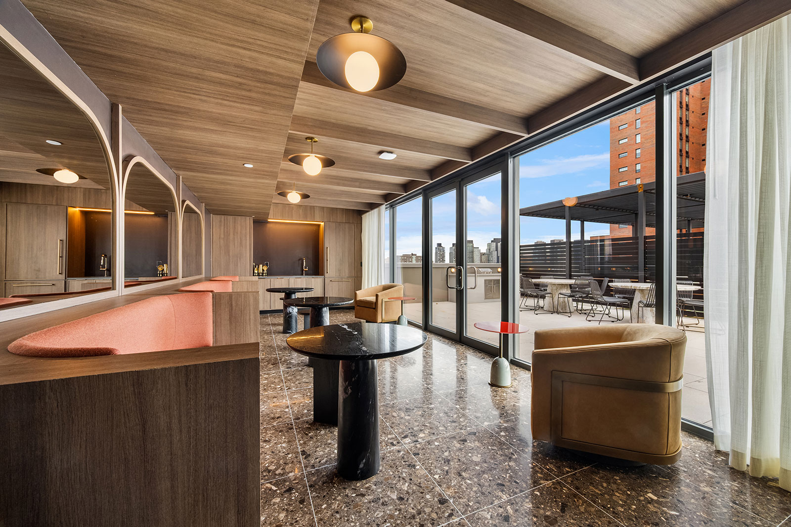 Rooftop terrace with ample open space, featuring grills and areas for gatherings that overlook NYC at 1975 Madison Ave.